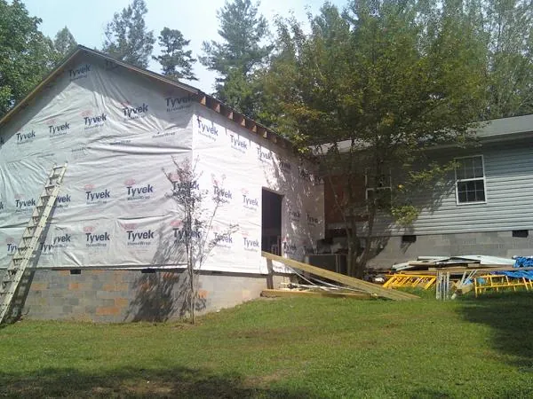 Tyvek wrapped gable on a new room addition beside an existing home in Waterford